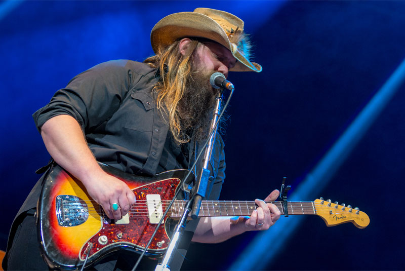 man playing guitar and singing